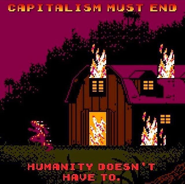 A still image from the vintage Nintendo game 'swamp thing' shows a house or barn on fire with a green lizard creature running out. Block text reads 'capitalism must end; humanity doesn't have to.'