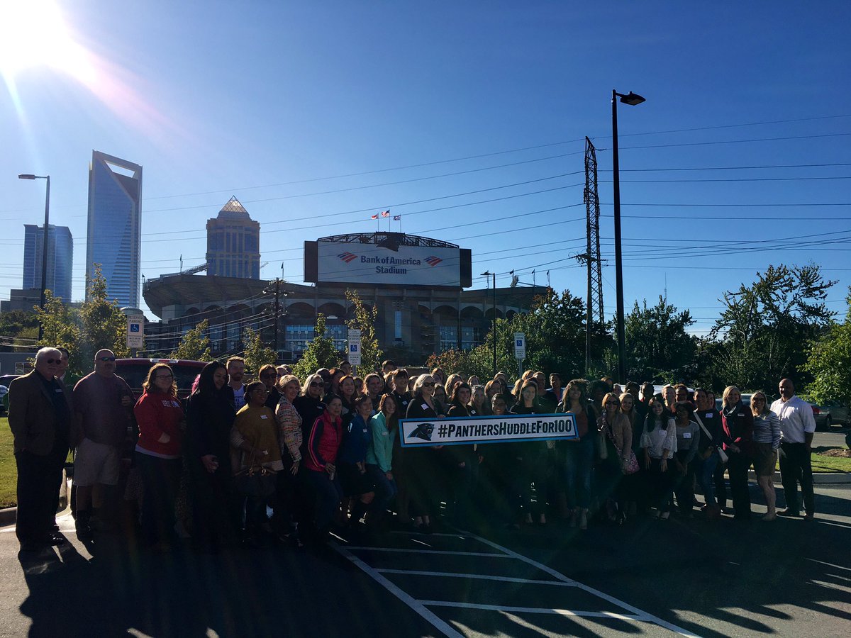 shareclt's tweet photo. With 80+ nonprofits represented in our crowd this morning we couldn’t resist a group photo to show support for #panthershuddlefor100! And where better for us to snap the shot than in front of #CommunityMattersCafe’s beautiful view of @BankofAmerica stadium, home of the @Panthers! https://t.co/pXzj5KMIAU