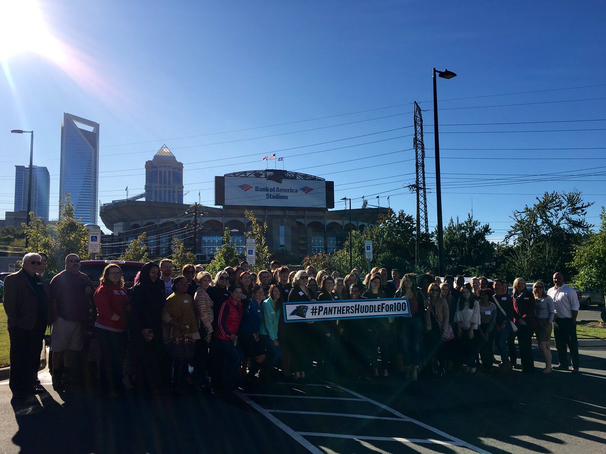 shareclt's tweet photo. With 80+ nonprofits represented in our crowd this morning we couldn’t resist a group photo to show support for #panthershuddlefor100! And where better for us to snap the shot than in front of #CommunityMattersCafe’s beautiful view of @BankofAmerica stadium, home of the @Panthers! https://t.co/pXzj5KMIAU