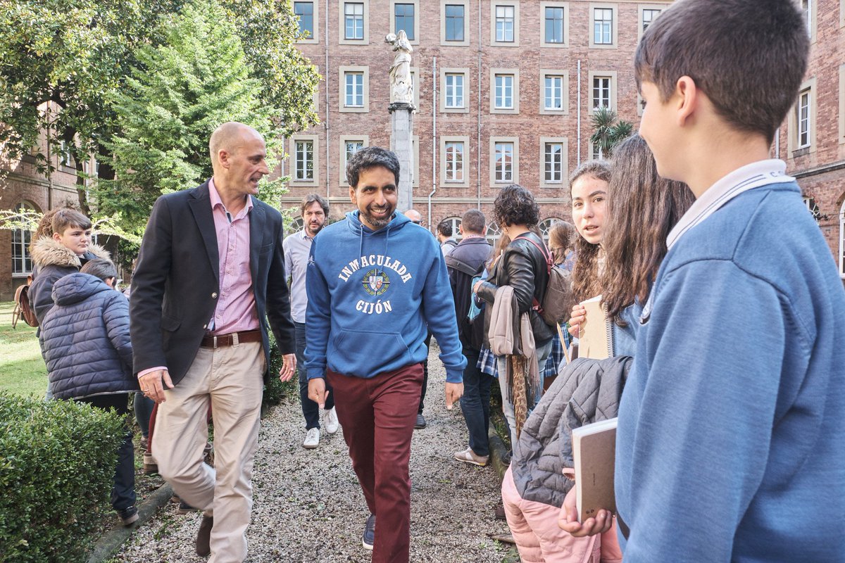 Sal Khan walks in the courtyard of a school in Spain and meets students.