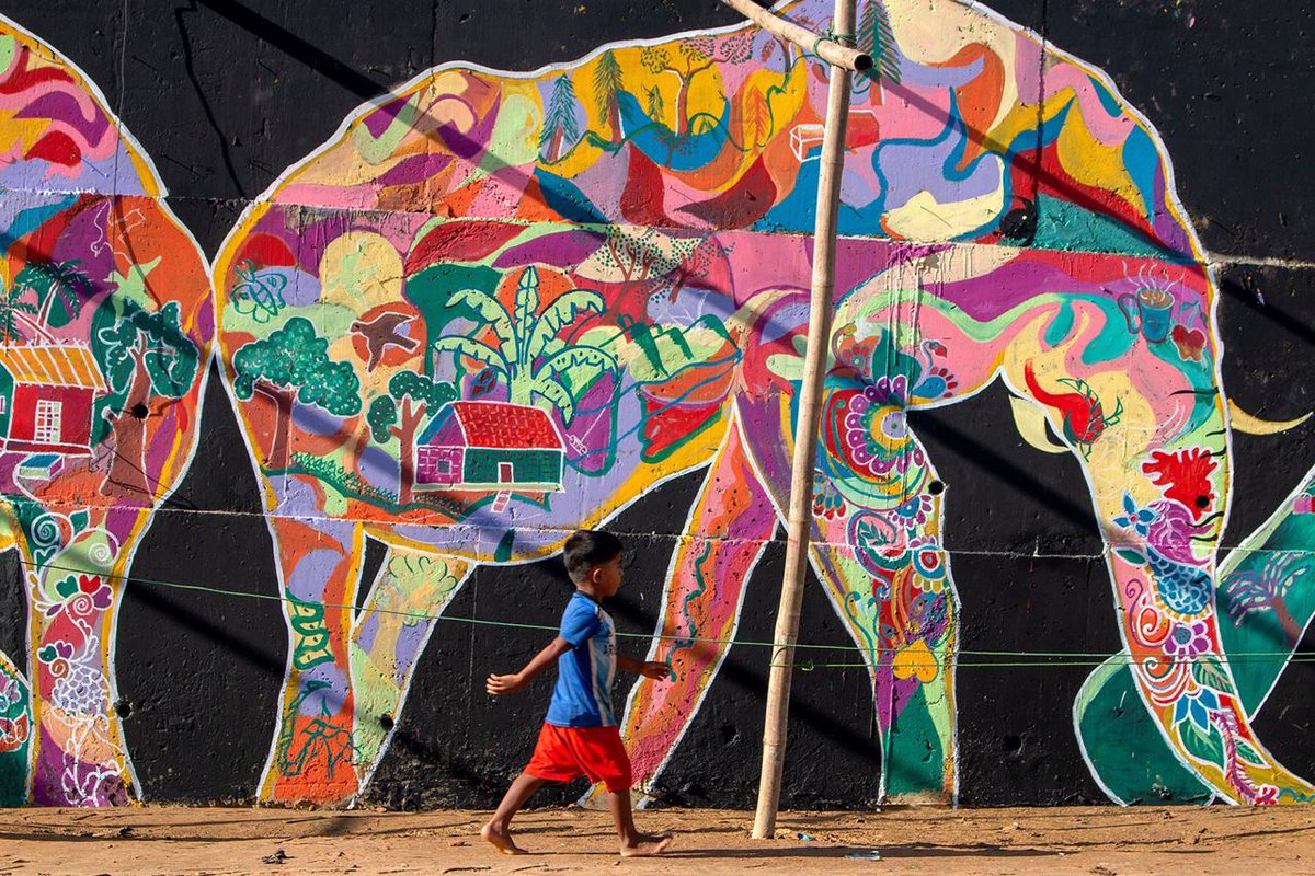 ArtolutionOrg's tweet photo. The dreams and memories of #Rohingya refugees now live on in elephants painted on the walls that protect them from landslides through the collaboration of our local Rohingya team of artists and @UNmigration in the largest refugee camp in the world. #artolution #jointheartolution https://t.co/w7Ks6CcITx