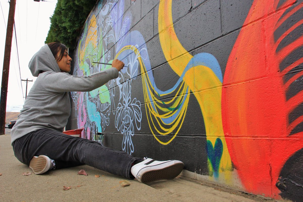 Photo of the Week – Making Murals – 10-17-19
Local artist Ashley Cardenas smiles as her brush strokes create a section of the massive mural of multiple artist's work taking shape on 24th Ave. See more photos of the masterpiece in the making at this link. ow.ly/MJOM50wO7ET