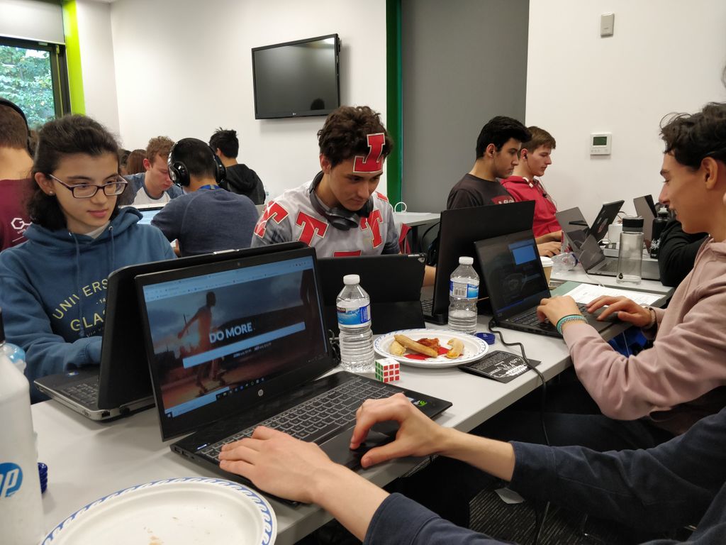 MLHacks's tweet photo. These hackers (including our very own budget super hero) are pondering which @Domaindotcom domain they're going to register for free this weekend at Do You Have The GUTS?! #GUHack https://t.co/55o9qFvjSi