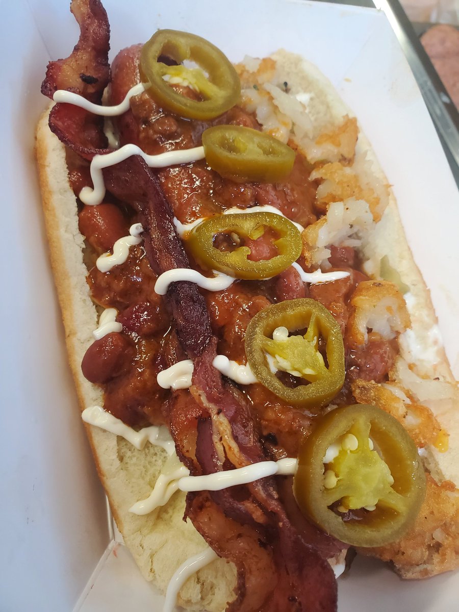 Hot diggity dog! Jalapenos, bacon tator tots, beef chili, pickles, tomatoes, grilled onions and a lil mayo graced this 100% beef hot dog