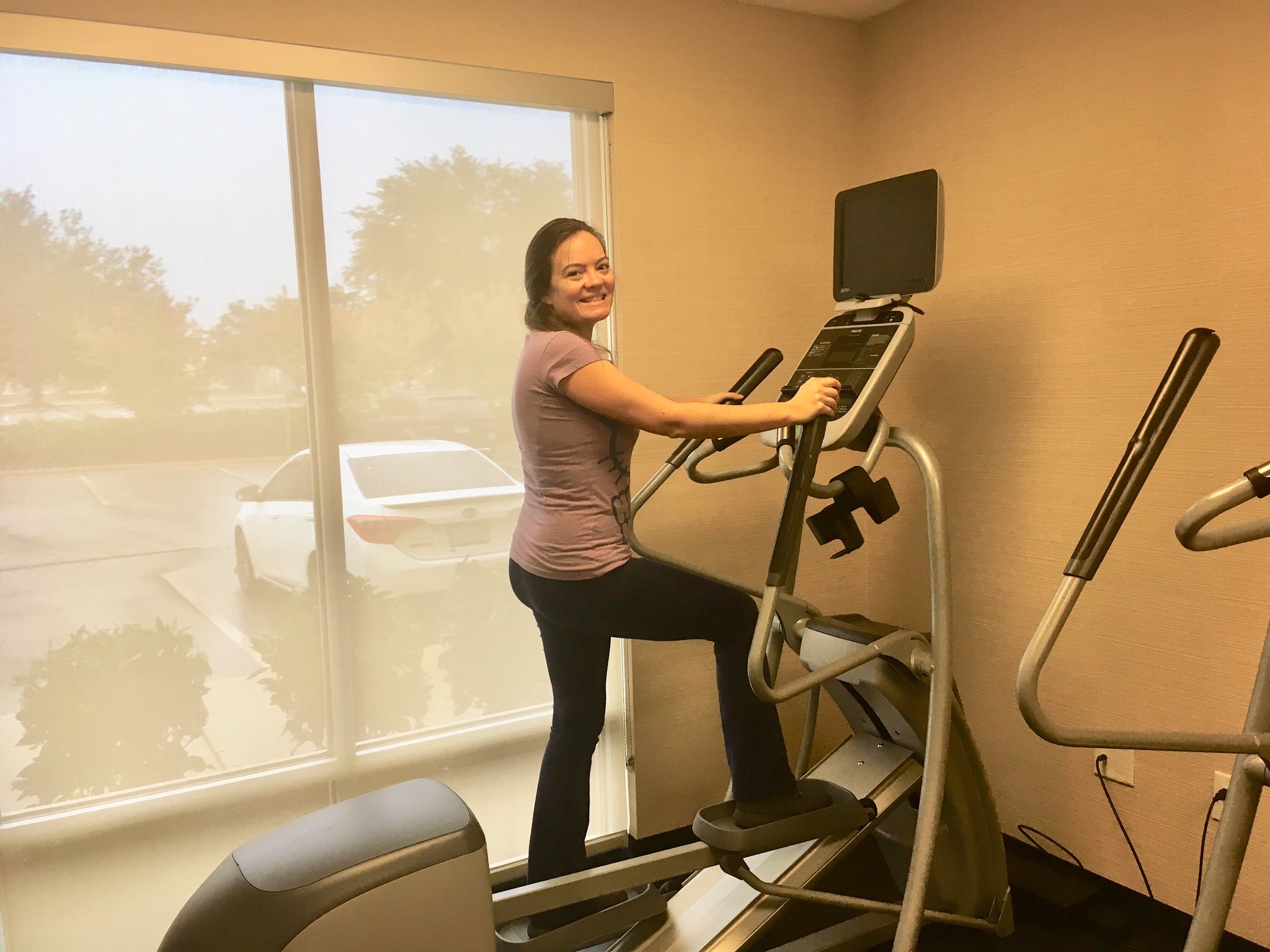 A woman on an elliptical in a hotel gym.