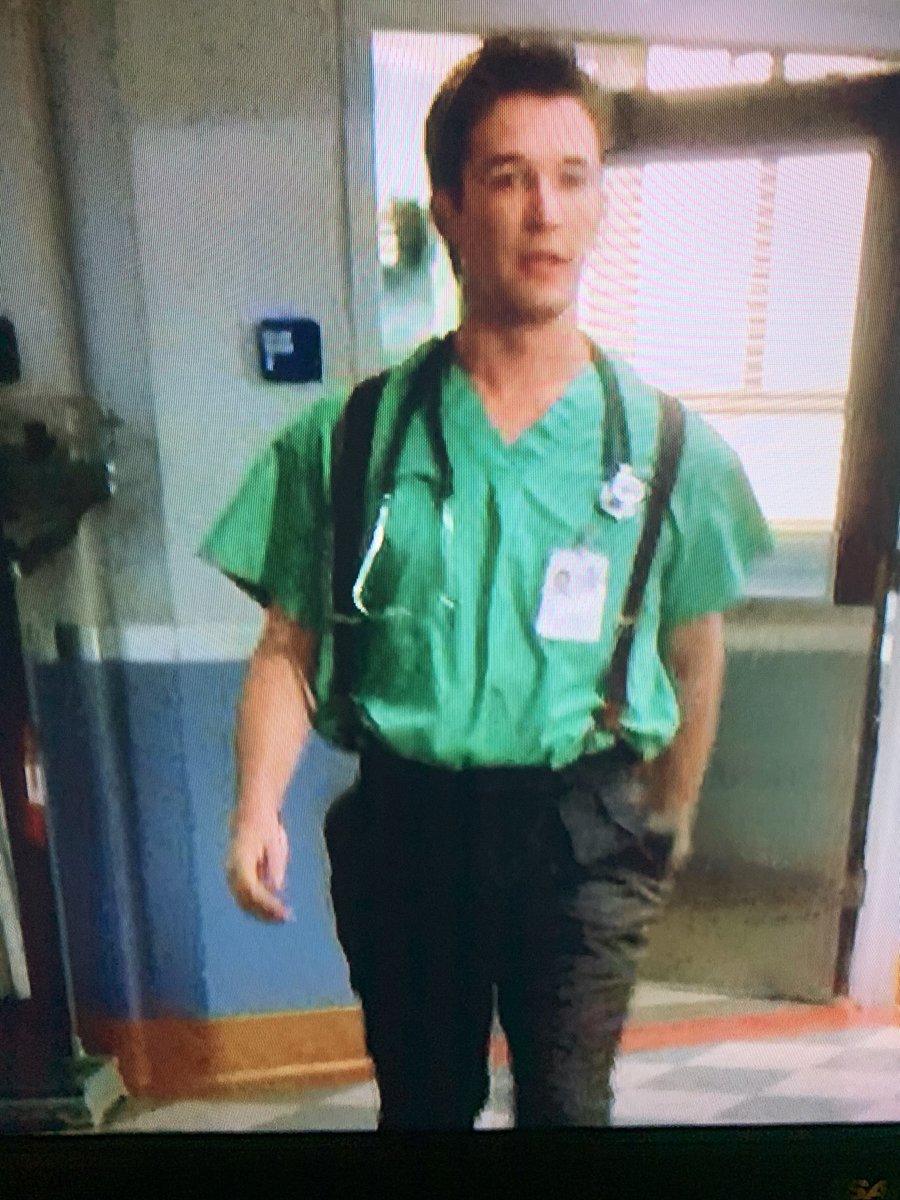 I need everybody to stop what you’re doing right now and look at this photo of John Carter wearing a scrub top tucked into dress pants with suspenders. Iconic.