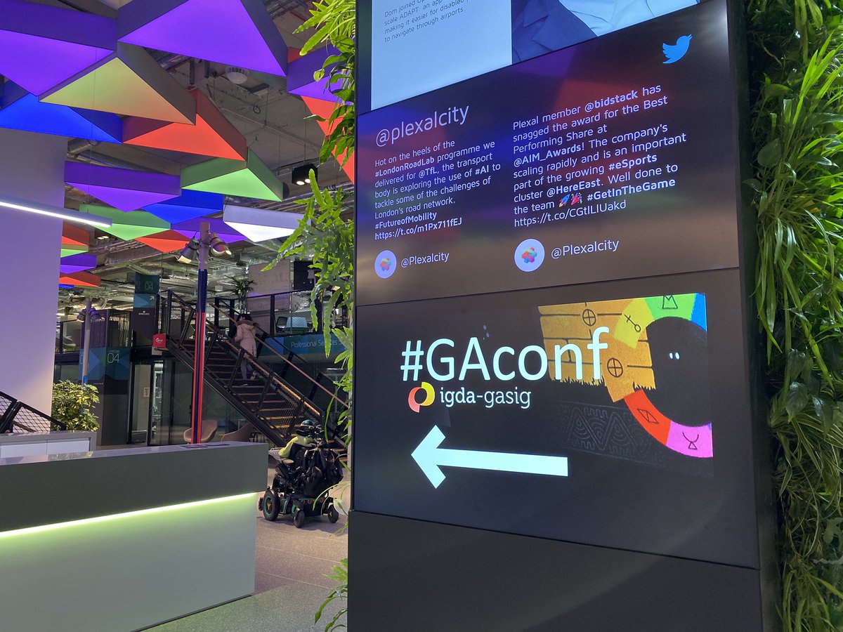 Sign for GACONF pointing down a colorful hallway.