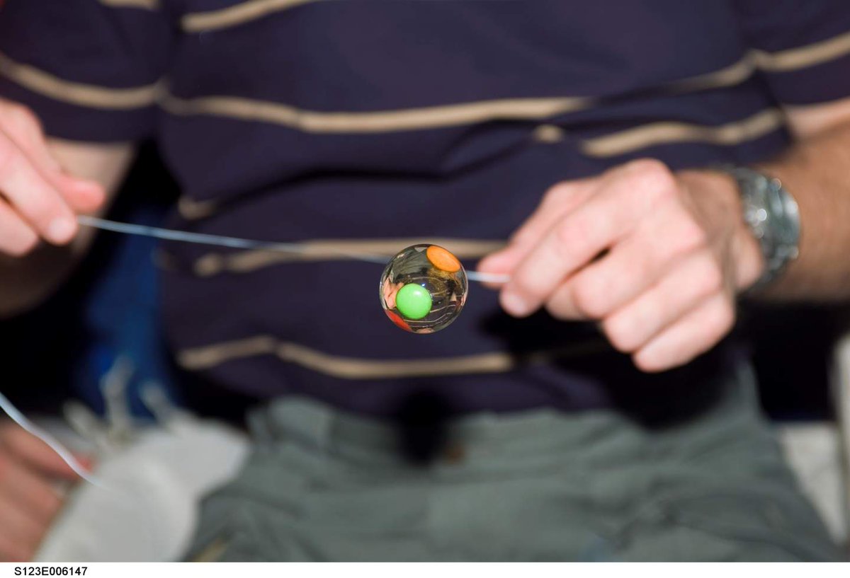 water bubble with green and orange candy trapped inside