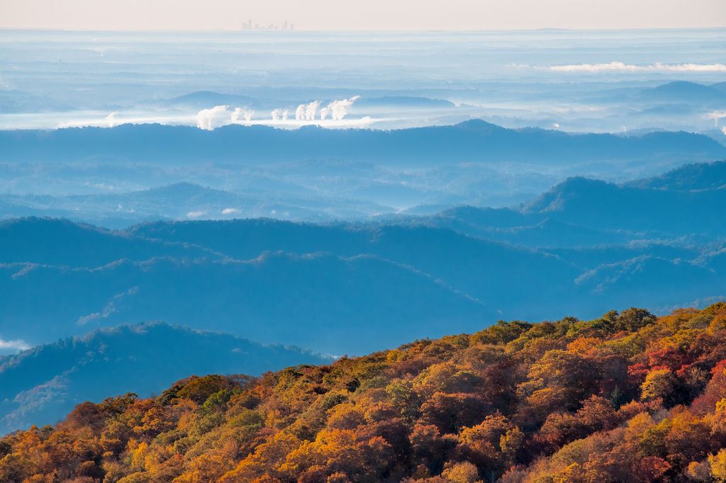 wxbrad's tweet photo. The Charlotte skyline rises on the horizon some 80 miles away as the crow flies, while fall color dominates the foreground in this view from Pilot Ridge Overlook on the Blue Ridge Parkway (milepost 301.8). Photo by Skip Sickler. https://t.co/DZygfybBEP