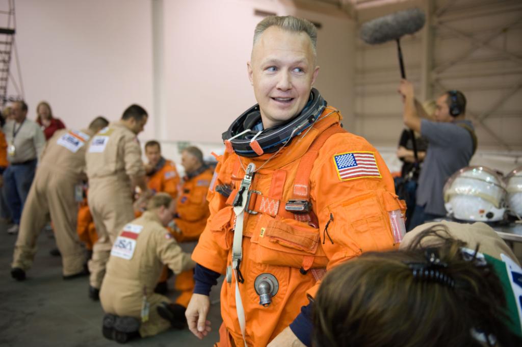 Astronaut Doug Hurley, STS-127 pilot, attired in a training version of his shuttle launch and entry suit, awaits the start of a water survival training session in the Neutral Buoyancy Laboratory (NBL) near NASA's Johnson Space Center.