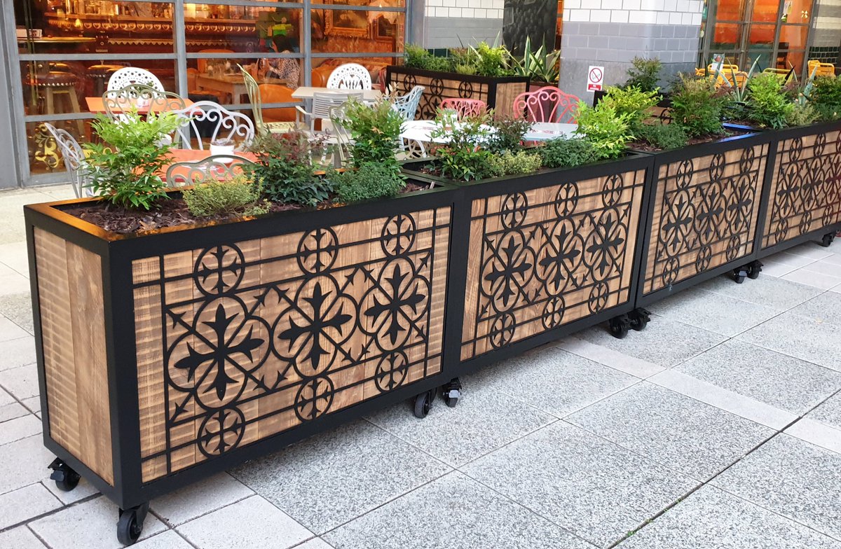 AELsolutions's tweet photo. We have just installed bespoke planters at the Cosy Club in Basingstoke. Made from vertical scaffold boards with a rustic african walnut and light oak finish, the decorative metal fret cut face and frame has been powder coated matt black to complement the nostalgic interior. https://t.co/odB766TOpt