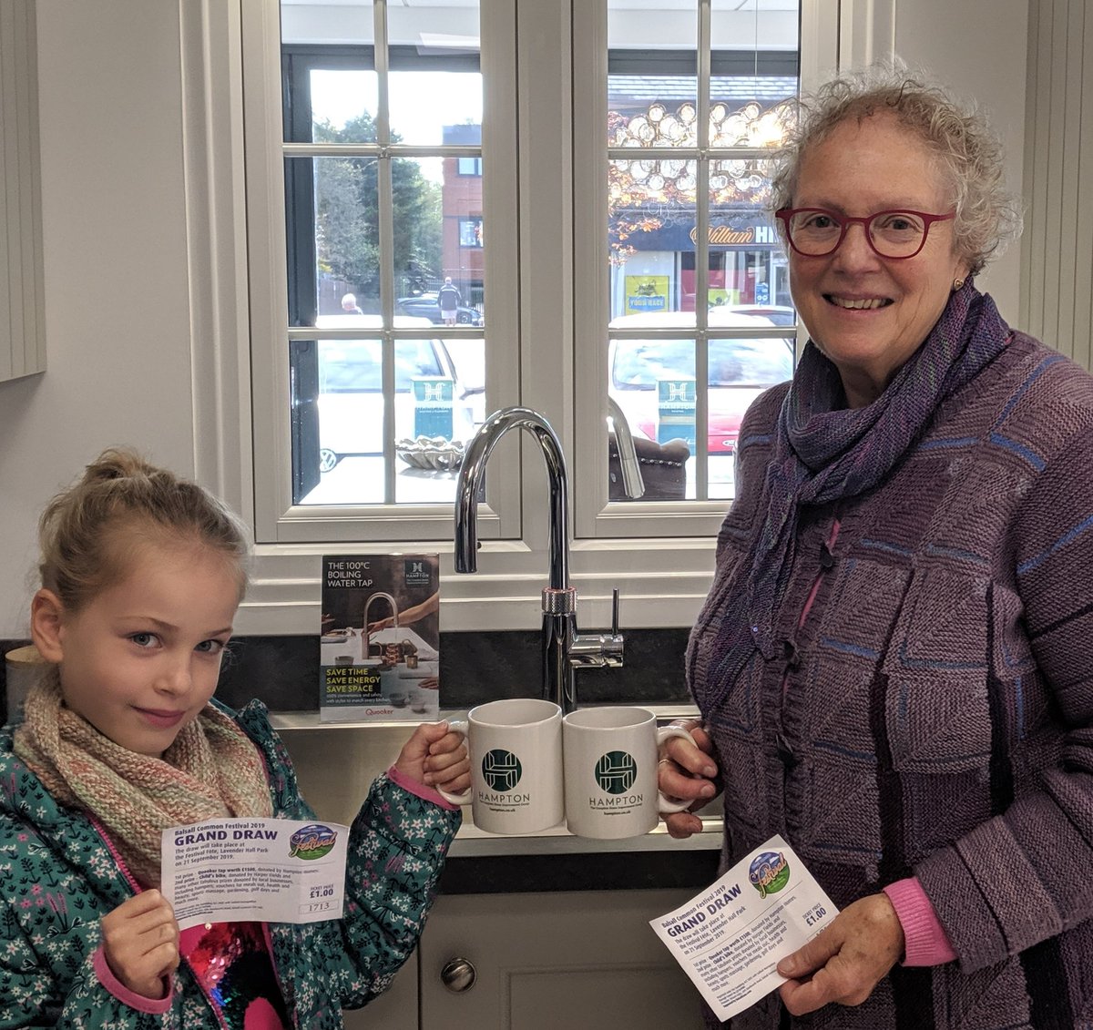 Hampton_Group's tweet photo. Meet the winners! Anthea, accompanied by 8 yr old grandaughter Thea, popped in today to claim her awesome @quookeruk kitchen tap, which was 1st prize at the @BCFest raffle. The tap provides instant boiling water &amp; has a handy cold water hose... total convenience in the kitchen 😃 https://t.co/rM1V9gXRvQ