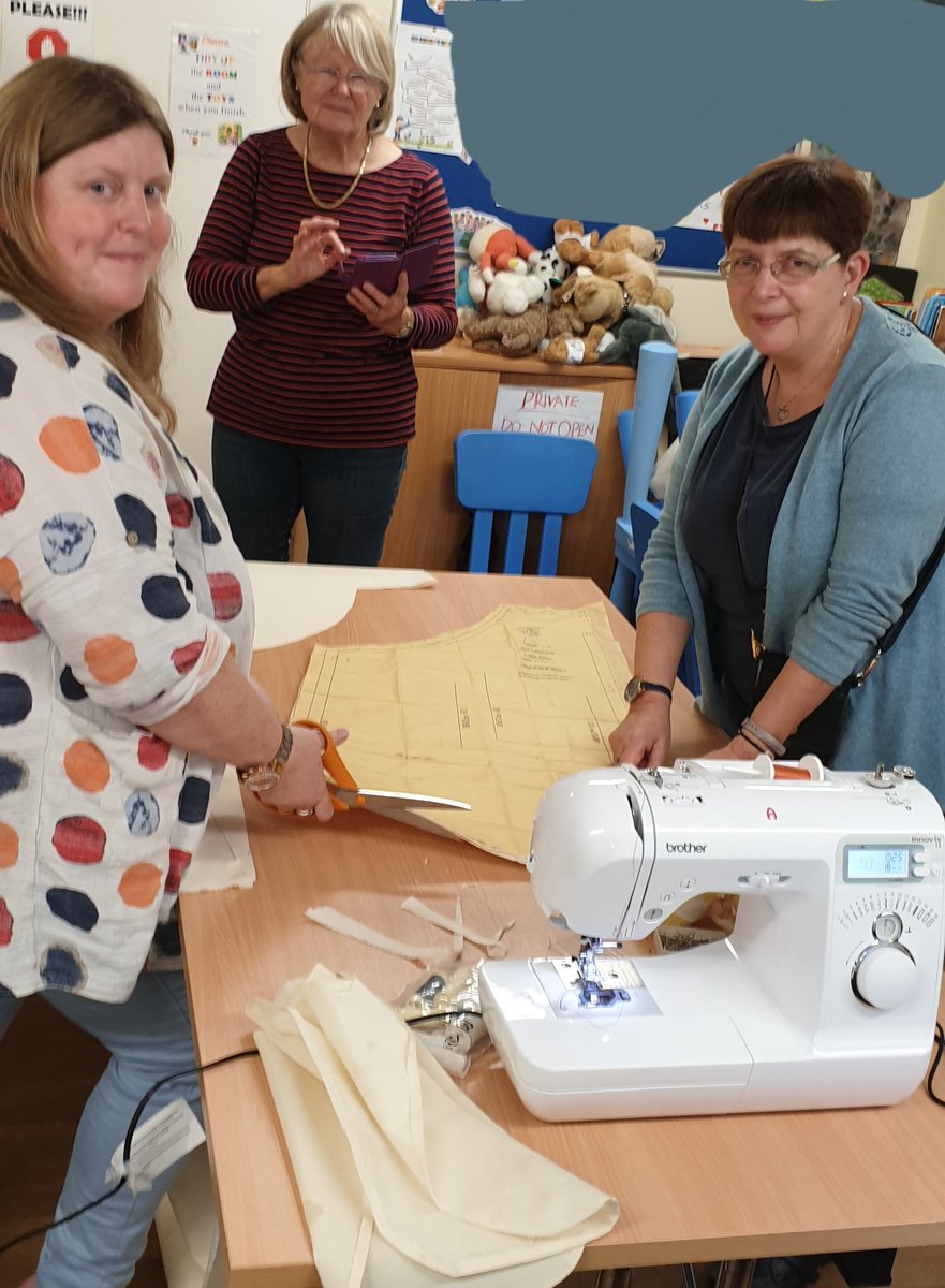 S_I_Manchester's tweet photo. Susan has been busy teaching the ladies at the refuge how to make aprons for the latest stage of the @MancWomensAid project. Now it's our turn...😊 #butterpillar #Soroptimists https://t.co/d3gcvhCQKV