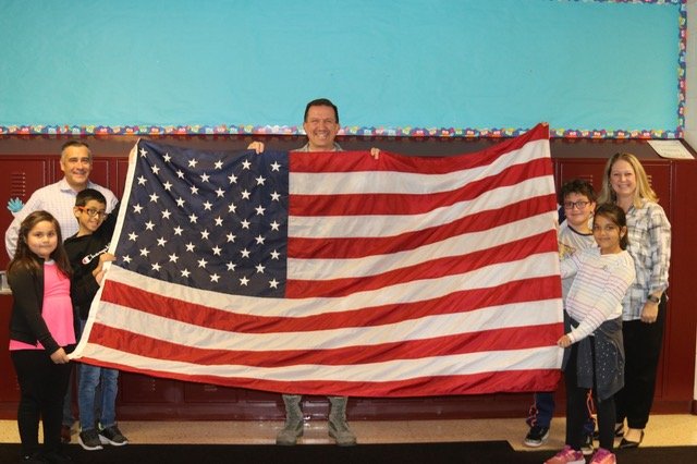 Sending our flag to the South Pole with  Lt. Col. Buckman.  We are so excited to see it flying in Antarctica!