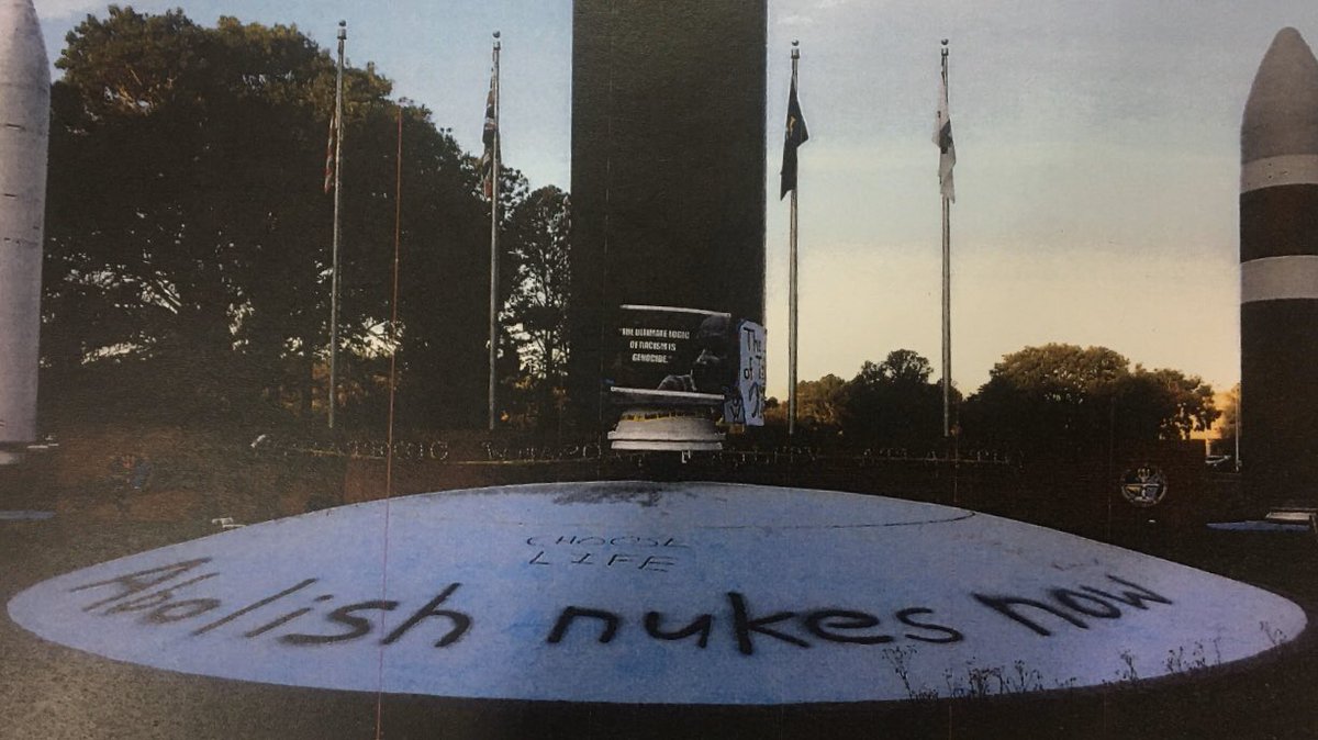 At the base, there is a monument to nuclear weapons including those it houses. Some of the seven activists “symbolically disarmed” the missiles depicted in this display. They hammered on them, hung banners and wrote text including “Abolish Nukes Now” and “Choose Life”.