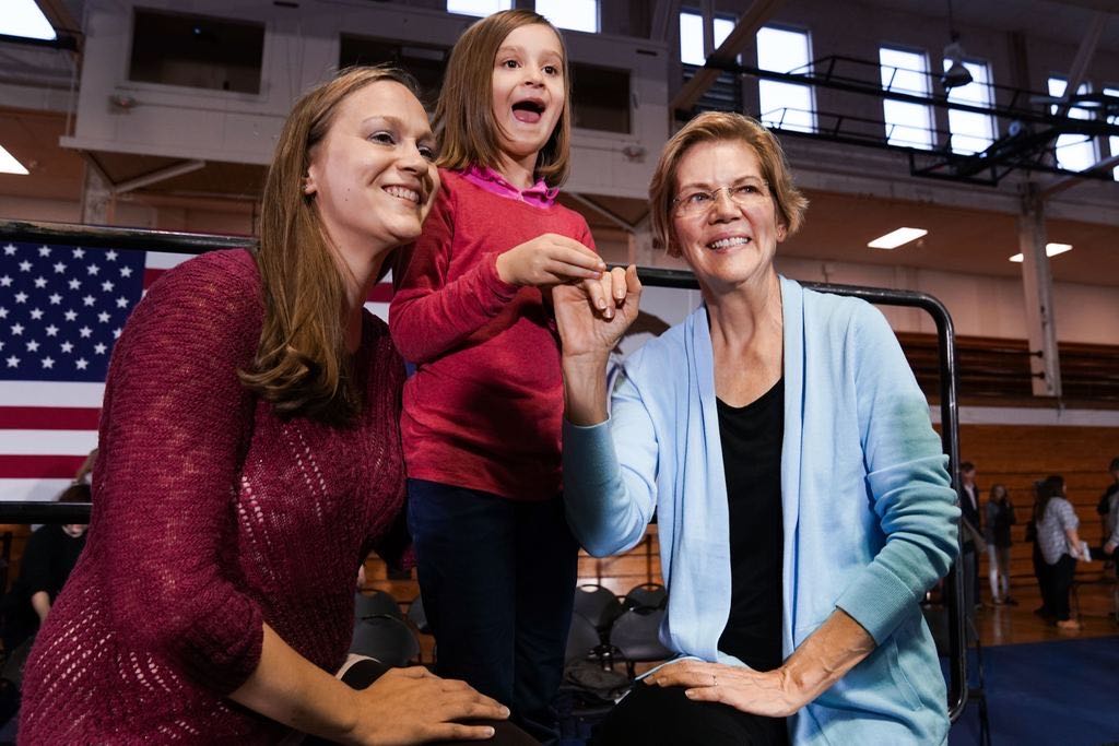 Elizabeth Warren poses with a family after the Cedar Falls Town Hall.