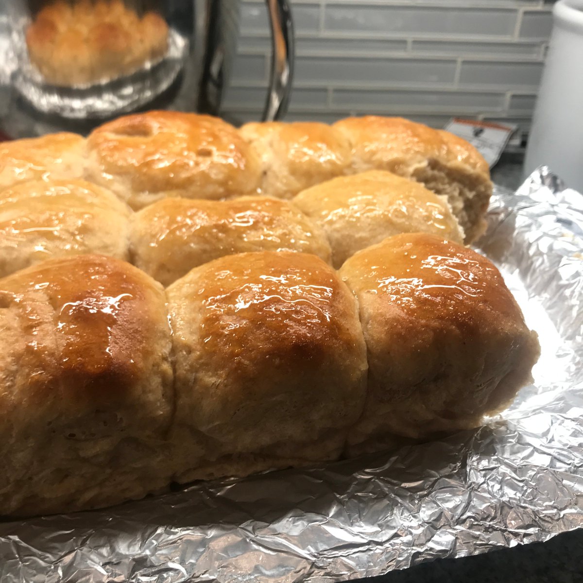 and this is bread #24, Honey-Wheat Dinner Rolls. I'm not thrilled with how the texture came out. I ended up having a family issue and running out the house & they rose for too long and ended up sort of craggy. But they were good. nice and stretchy and chewy. classic dinner roll.