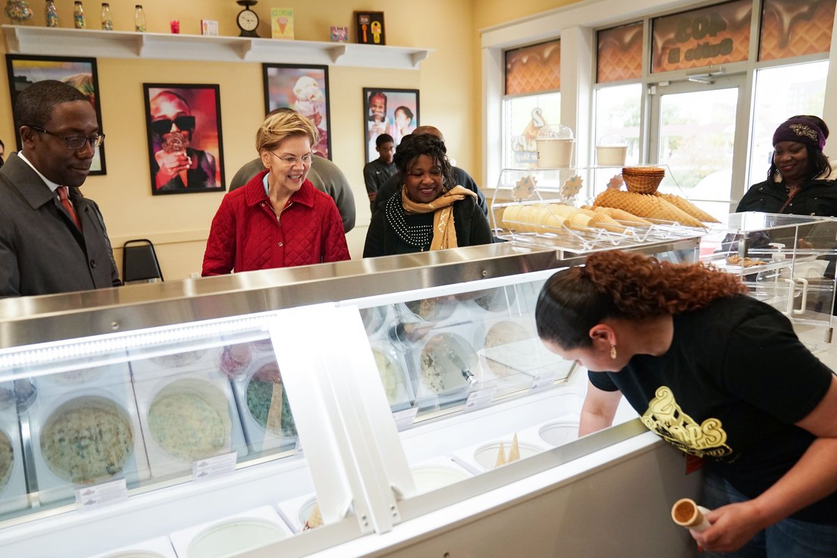 Elizabeth Warren selects an ice cream flavor at a shop in Waterloo, Iowa.