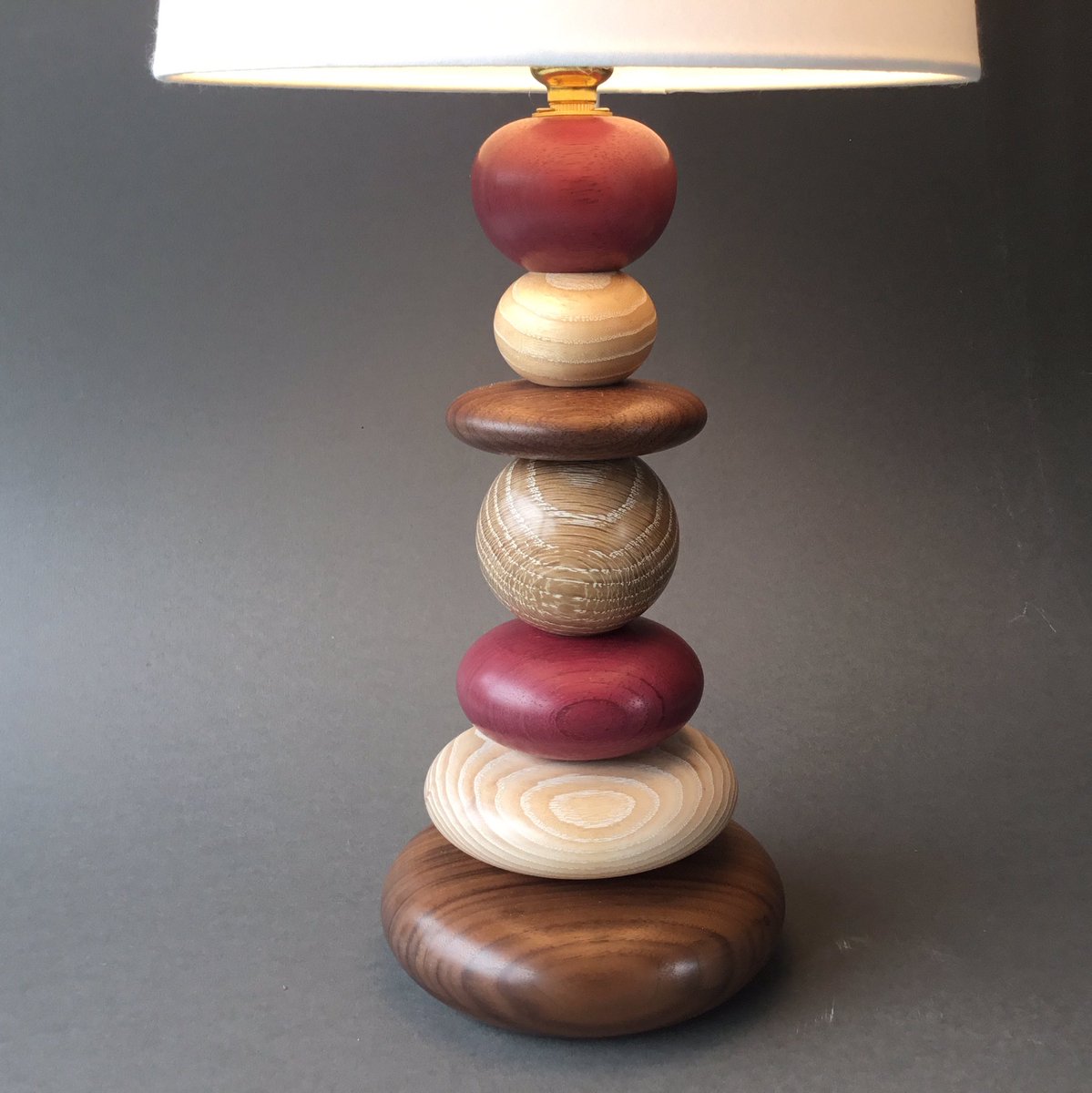 annawoodturner's tweet photo. A new Pebbles lamp is heading to the Shoreham Art Gallery today. This one features Walnut, Limed Ash and Oak as well as Purpleheart from Ashwells Reclaimed Tropical Timber @ashwells2 @shorehamartgallery #annawoodturner #turnedlamp #pebbles #woodart #Purpleheart https://t.co/fJVSj07aJ6