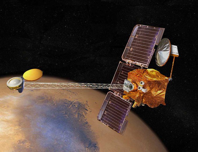 In an artist's depiction of Mars Odyssey, the spacecraft is seen in orbit around the red planet, back dropped against the starry expanse of space. The Odyssey mission mapped many of the chemicals on Mars’ surface, and successfully determined that there were large bodies of water beneath the Polar Regions on the Red Planet.