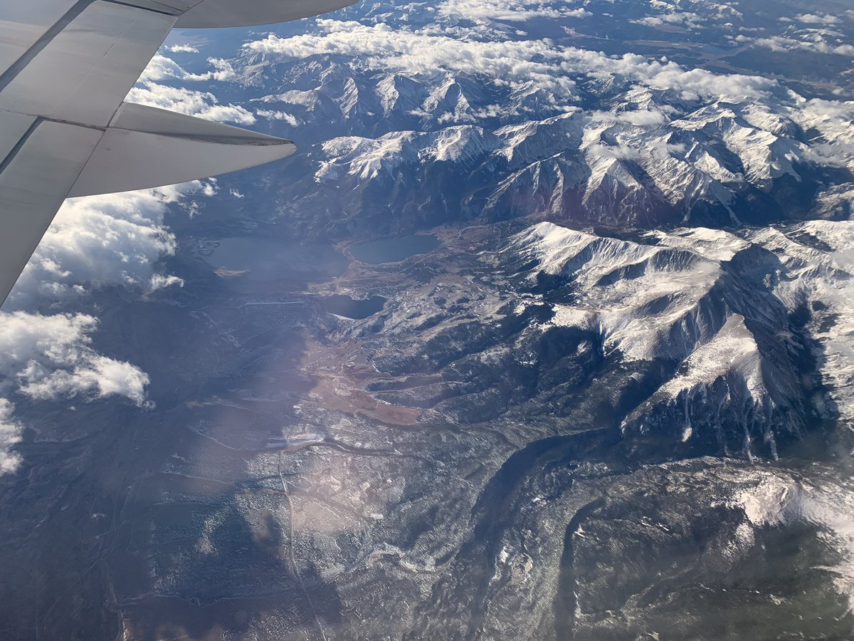 Snowcapped mountain range enclosing lake-filled valley (taken at 35000 feet).