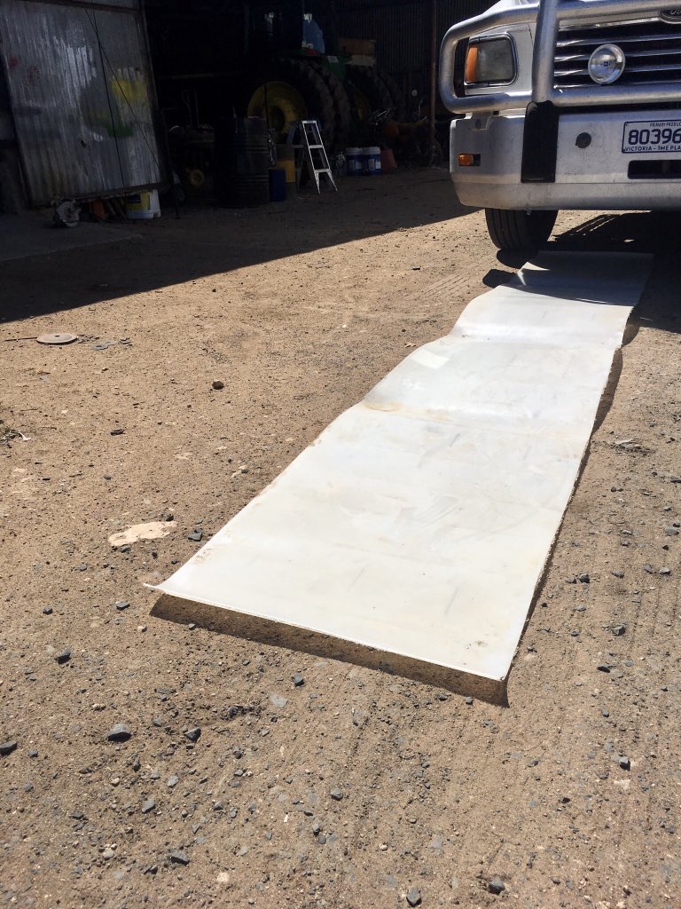 RodPohlner's tweet image. This piece of plastic came from the middle of a shuttle. I’d used the ends for another job and had this left over. It slippery and long so great for helping me slide under things but not very absorbent when you spill oil on it, so now I throw  a bit cardboard on top of it as well