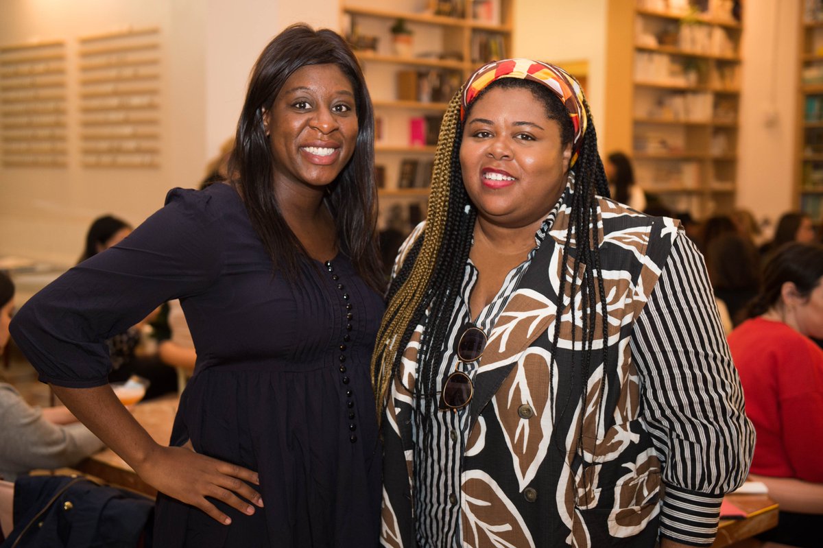Closeup of Pipeline Angels member Ife Babatunde & Chana Ginelle Ewing, founder of GEENIE (Pipeline Angels portfolio co.), both standing and bookcase behind