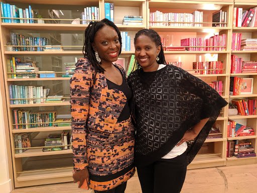 Closeup of Autumn Adeigbo (Pipeline Angels portfolio co. founder) and Pipeline Angels member Anna Banks, both standing and bookcase behind