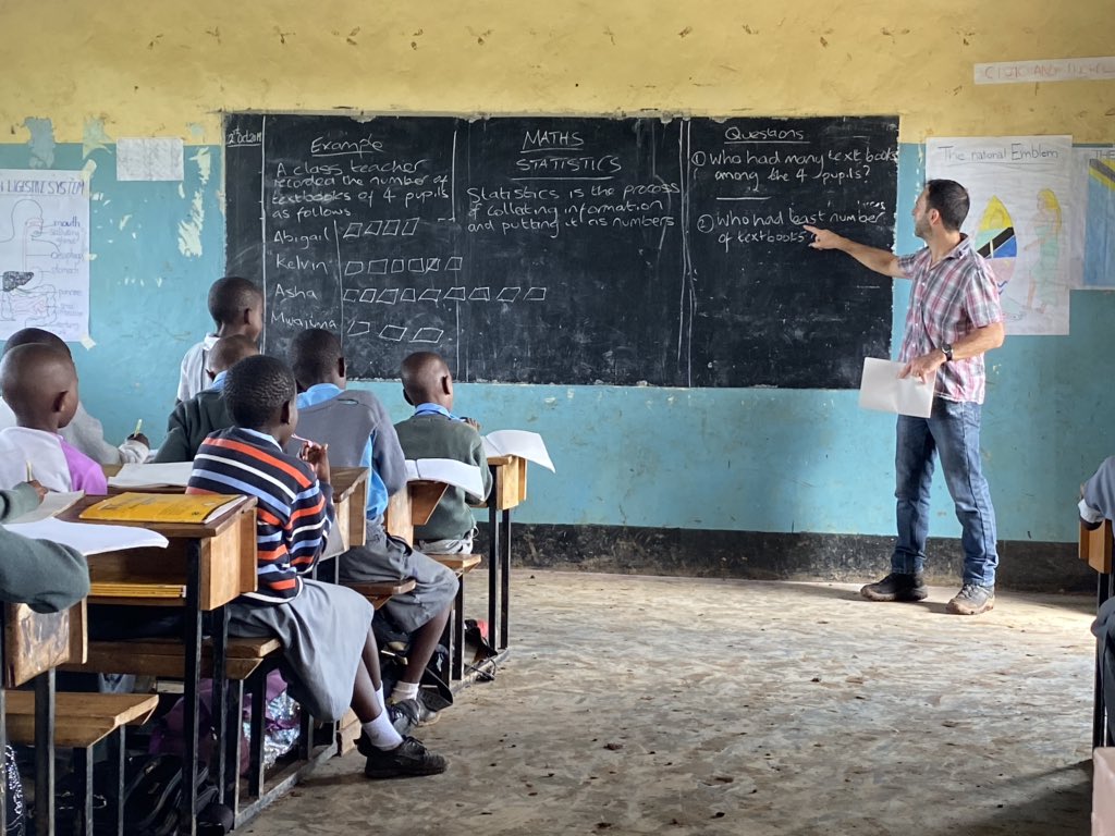 Mr Humphreys and Mr Peters striking a pose in front of the SHS-funded library at KYGN School in Tanzania, and Mr Peters in his natural habitat with Primary 3 <a href="/SurbitonHigh/">Surbiton High School</a> <a href="/garypet11037034/">Gary Peters</a> <a href="/LibSHS/">SHS Library</a> @cstewartshs <a href="/kingcantsing/">Byron King</a>