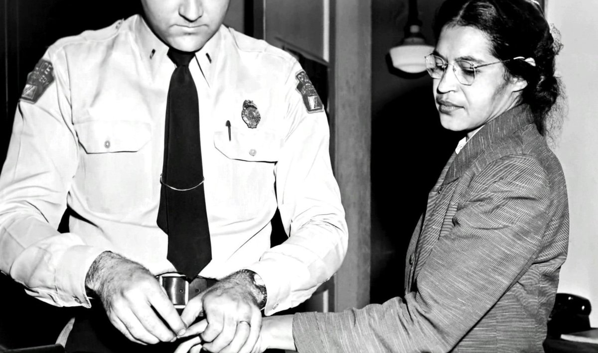 Photo of Rosa Parks with a white police officer after being arrested in Montgomery.