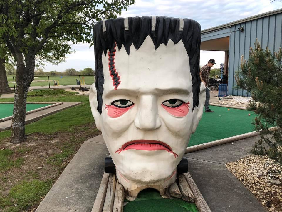 CouplePutts's tweet photo. Puttober Day 24 - the giant Frankenstein head on the Mini Haunts course at Smiley's Golf Course in Lenexa, KS. Review coming on Halloween! #puttober https://t.co/ex2uoZbjSN