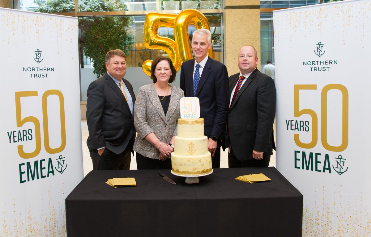 NorthernTrust's tweet image. Our London office yesterday celebrated 50 years of 
Northern Trust's presence in the EMEA region. Here photographed (L-R) are CFO Biff Bowman, EMEA president Teresa Parker, chairman and CEO Mike O’Grady, and James Hillery, one of our employees who baked the celebratory cake.