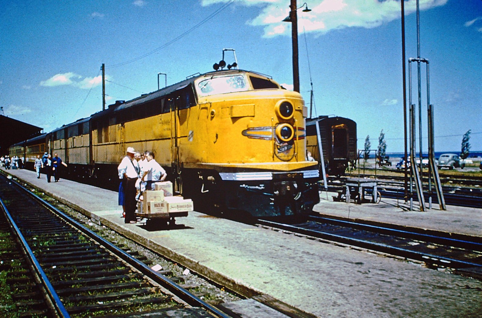 American-Rails.com on X: Chicago & North Western Erie Built #6001-A  boards at the Lake Front Depot in Milwaukee, Wisconsin with what is likely  a '400' consist in June, 1956.  / X