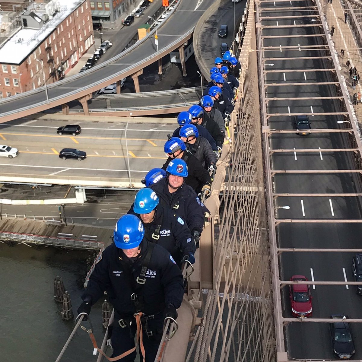 NYPD Officers climbing the Brooklyn Bridge