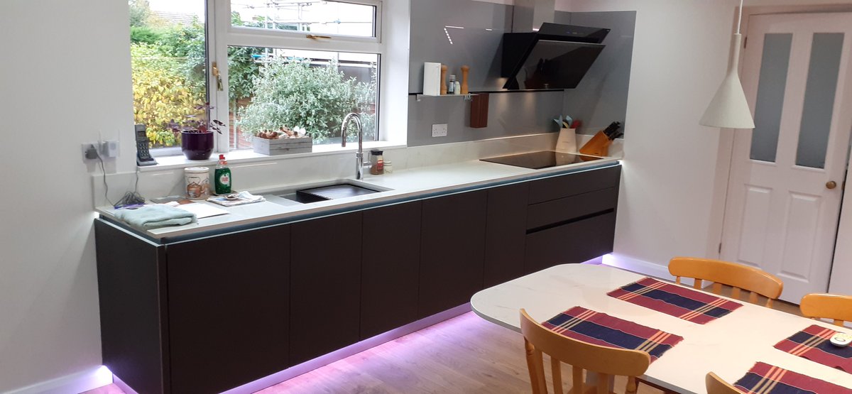 Pronorm XLine matt organic glass fronted kitchen with Dekton tops Siemens Studioline appliances Quooker Flex tap Blanco sink and Quickstep Livyn floor from Stortford Kitchens