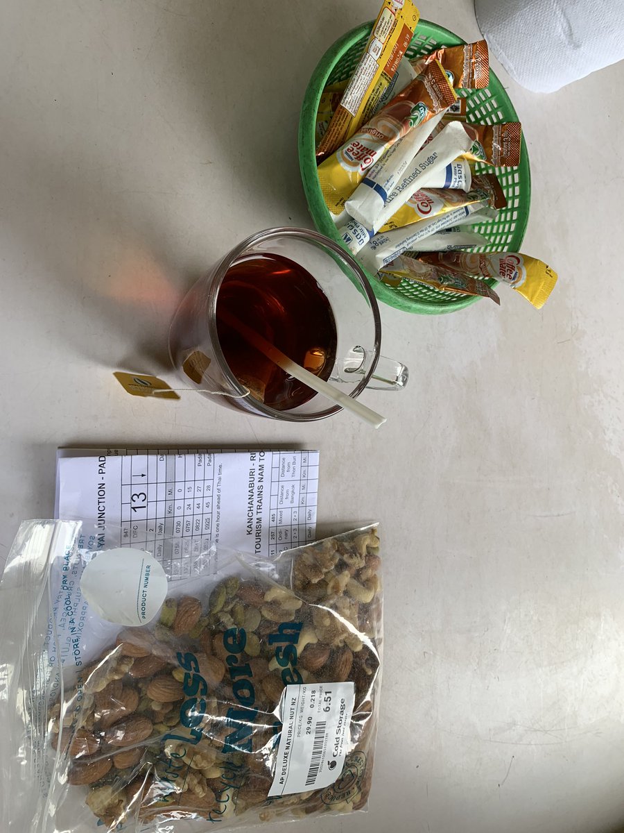  #DiningCar ( @_DiningCar) of Special Express № SP38 Going from Sungai Kolok to Bangkok. I’m enjoying tea with nuts. The Thai Railway timetable is lying handy to check stops along the route.