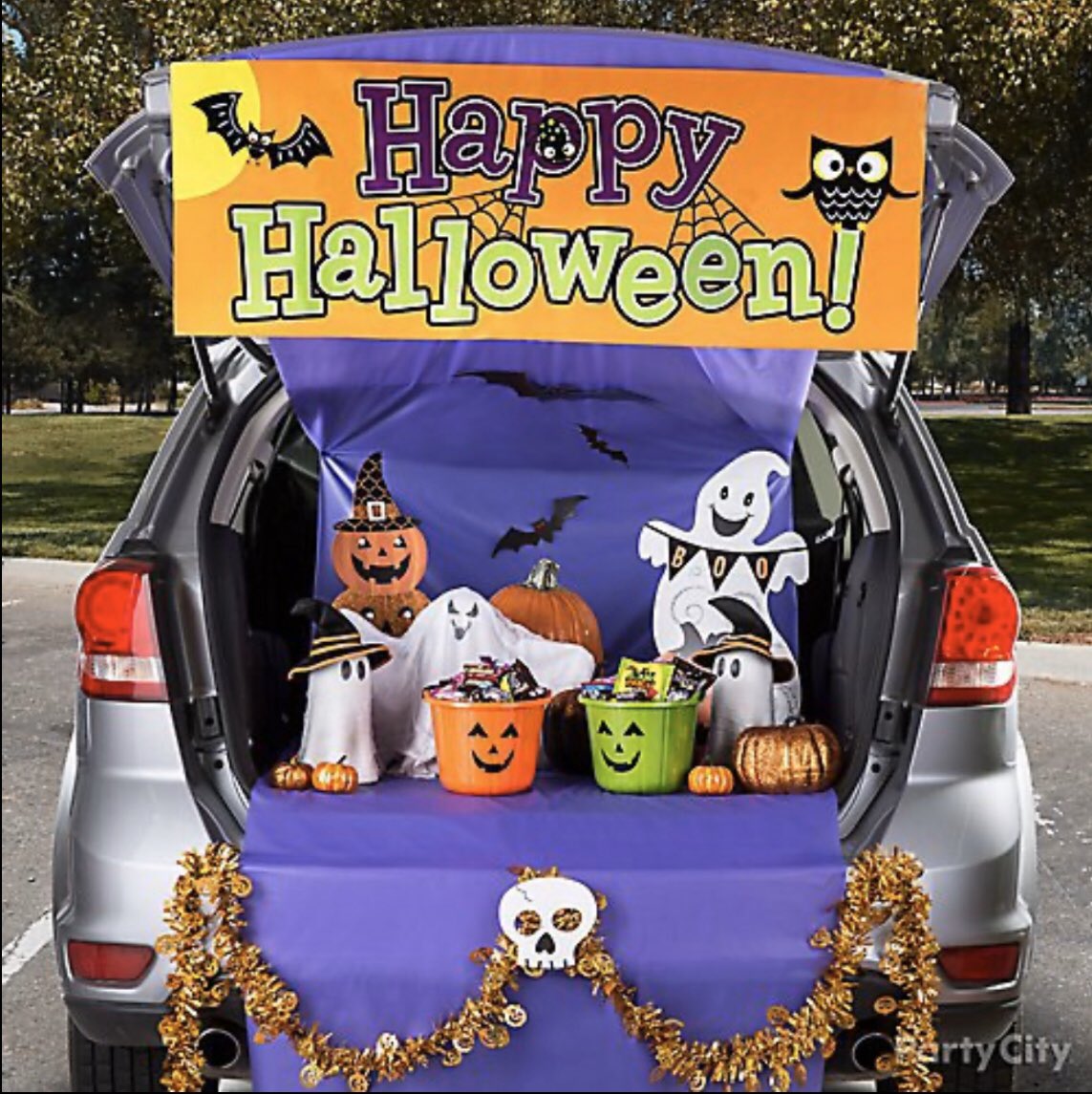Car trunk with Halloween decor and treats.