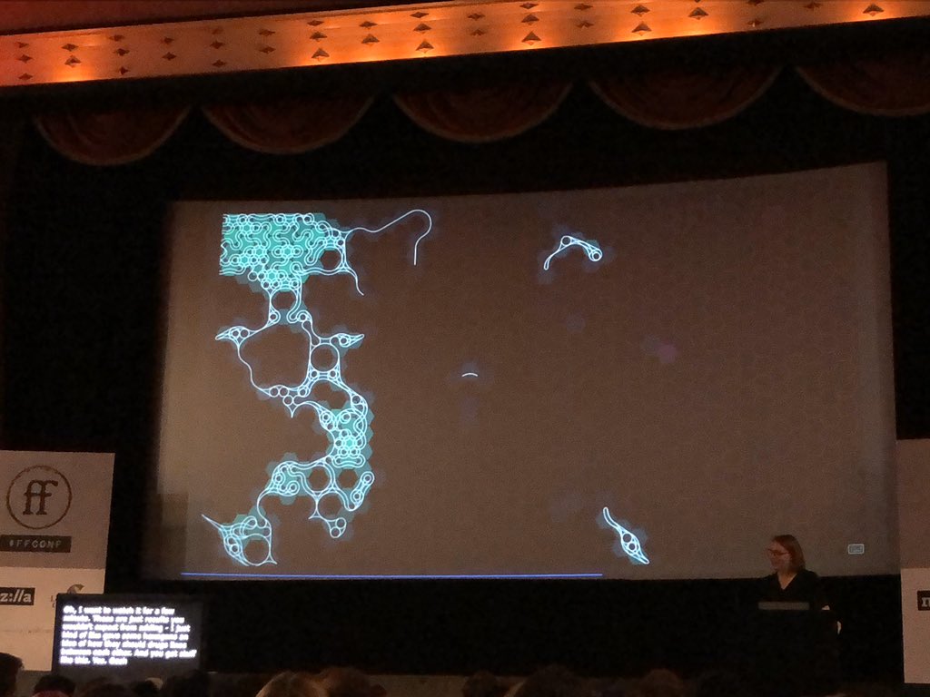 A single frame from animated generative art, with interconnected lines built up to form patches of glowing blue and white hexagons in a sea of black.