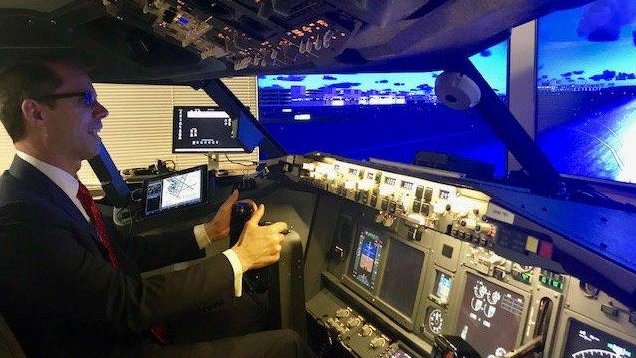 USGSA's tweet photo. Check out GSA's Public Buildings Service Commissioner, Daniel Mathews, in a flight simulator while visiting the @USDOT Volpe National Transportation Systems Center Exchange Project in #Cambridge, MA. #AviationHistoryMonth #GSAPBS https://t.co/OY4CO2FyPQ