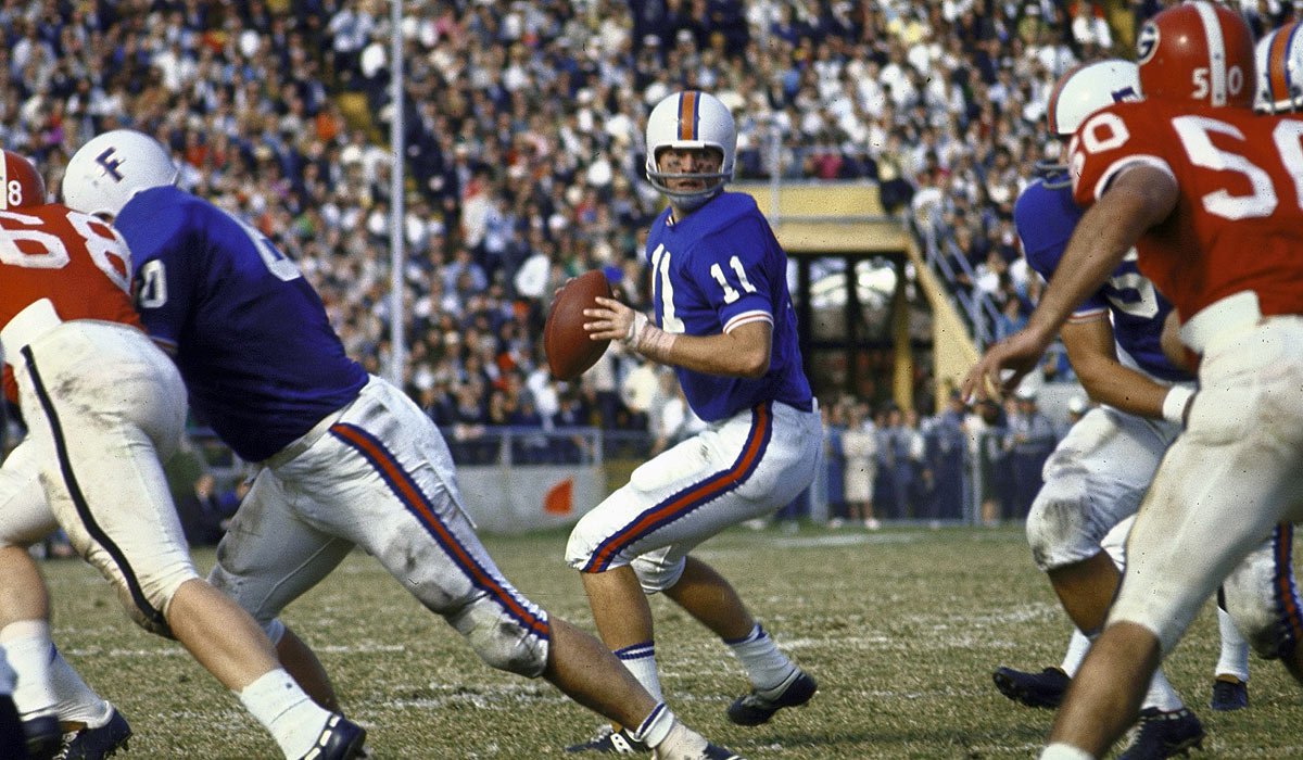 After a 3yr hiatus, the 1966 season featured the white helmets Florida fans most often recognize; Spurrier’s block F with a B/O/B stripe. This same helmet design was replicated in the 2006 throwbacksFlorida finished the season 9-2 and Spurrier walked away with a Heisman trophy.