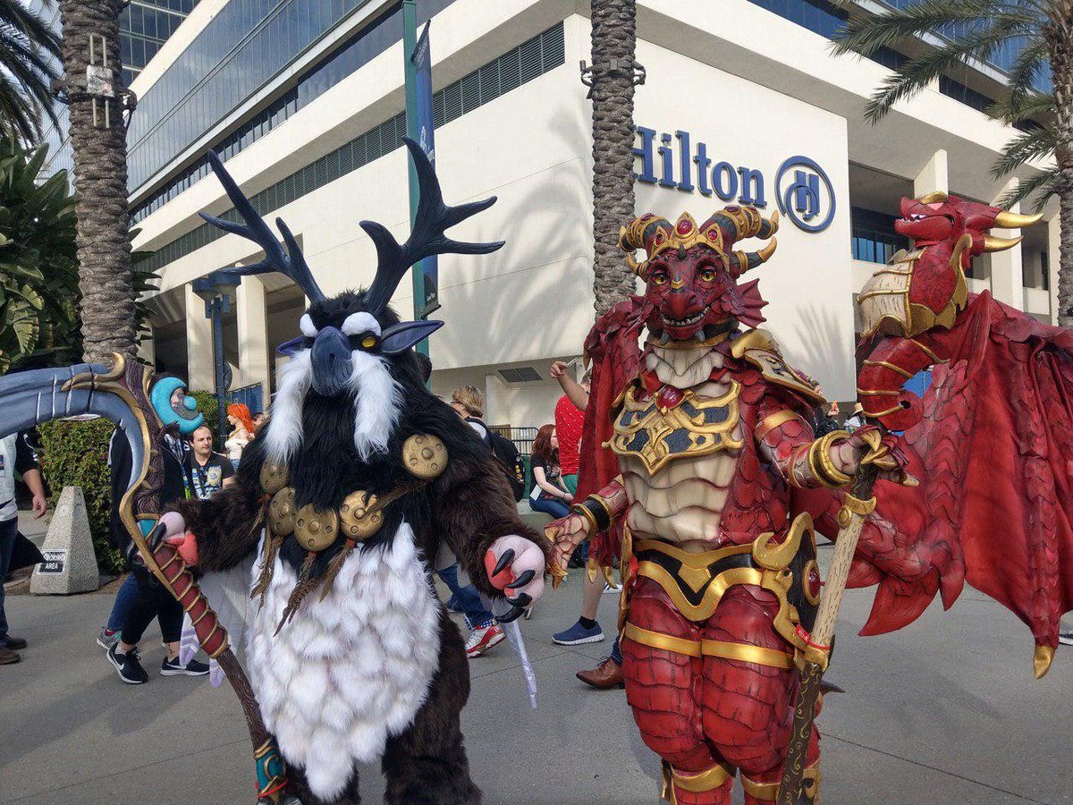 It's fursuit! Sort of. Anyways. Happy #FursuitFriday! #BlizzCon2019 was a blast last weekend. The moonkin came out and terrorized the land with huggable chubbiness. 
Alexstrasza next to me is @sixthleafclover, one of this year's costume contest finalists. We are both finalists!