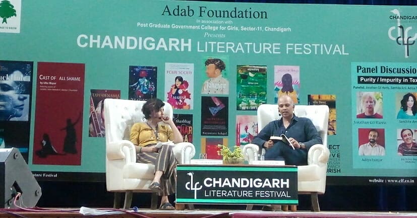 CLFChd's tweet photo. Mahesh Rao reading a passage from his book - Polite Society. ReimaginingJane Austen's Emma in contemporary Delhi to portray a society whose polished surface often reveals far more than is intended. 
#ChandigarhLiteratureFestival #CLF #2019 #celebratebooks #litfest #PoliteSociety https://t.co/VuYkjqV8dH