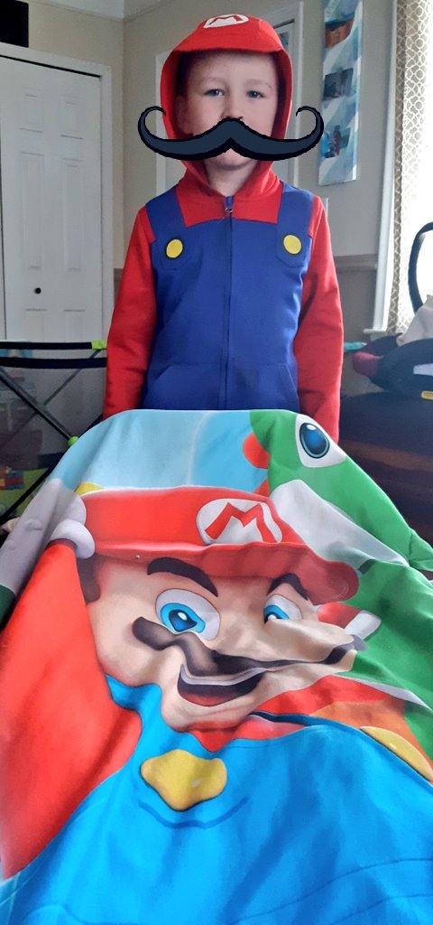JTonegatto's tweet photo. Wrapped up in a cozy blanket working on my homework this week... I live with a resident expert on this week's subject: video games! 😂🍄#cep813 https://t.co/aT3BZlGDvN