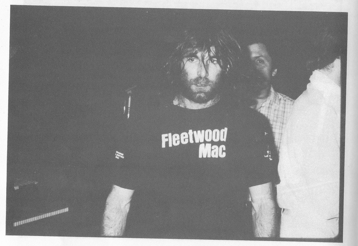 We need your help with a collaborative thread. Here's a pic of Dennis Wilson wearing a Fleetwood Mac t-shirt. Next photo should be a Fleetwood Mac member wearing a t-shirt with another artist or band on it. Let's see how far we can take this.