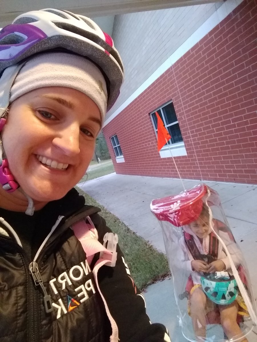 SarahAminNC's tweet photo. Yesterday #bikekid complained of the morning cold. #NotTodayKid. Got that rain cover on to block the wind. She was stoked. #biketoschool #bikingfam https://t.co/84XP9CphGy