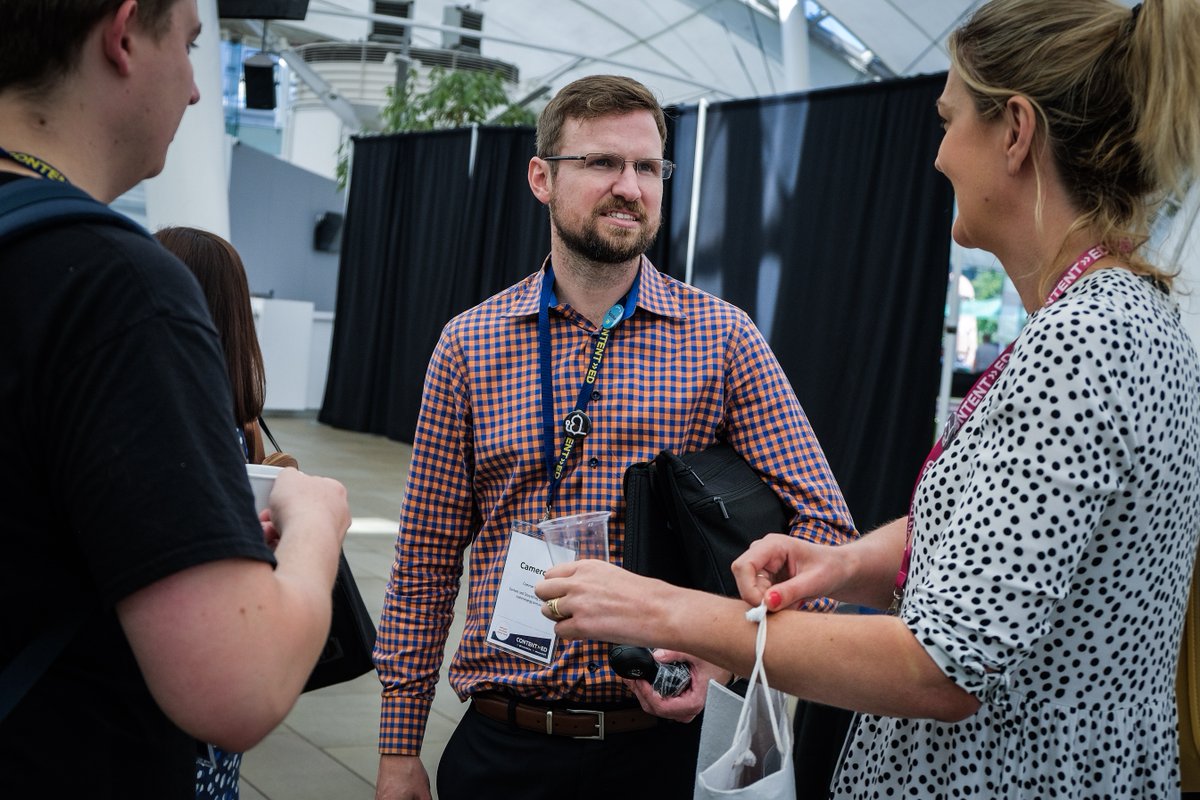Delegates talk inside at ContentEd 2019 during a session break