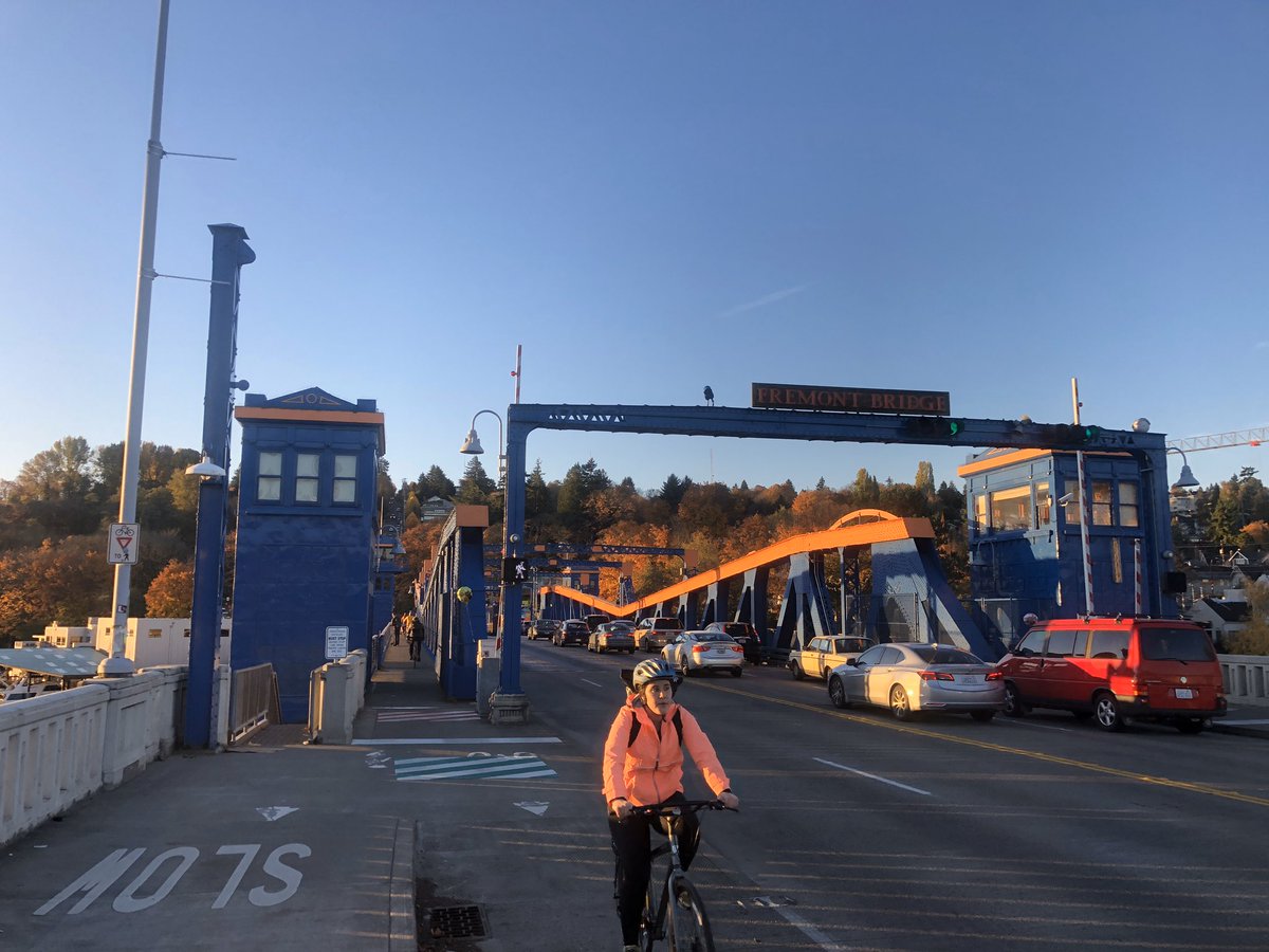 Bike rider in pink rides north off the Fremont Bridge