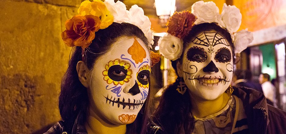 two teens in day of the dead face paints/attire