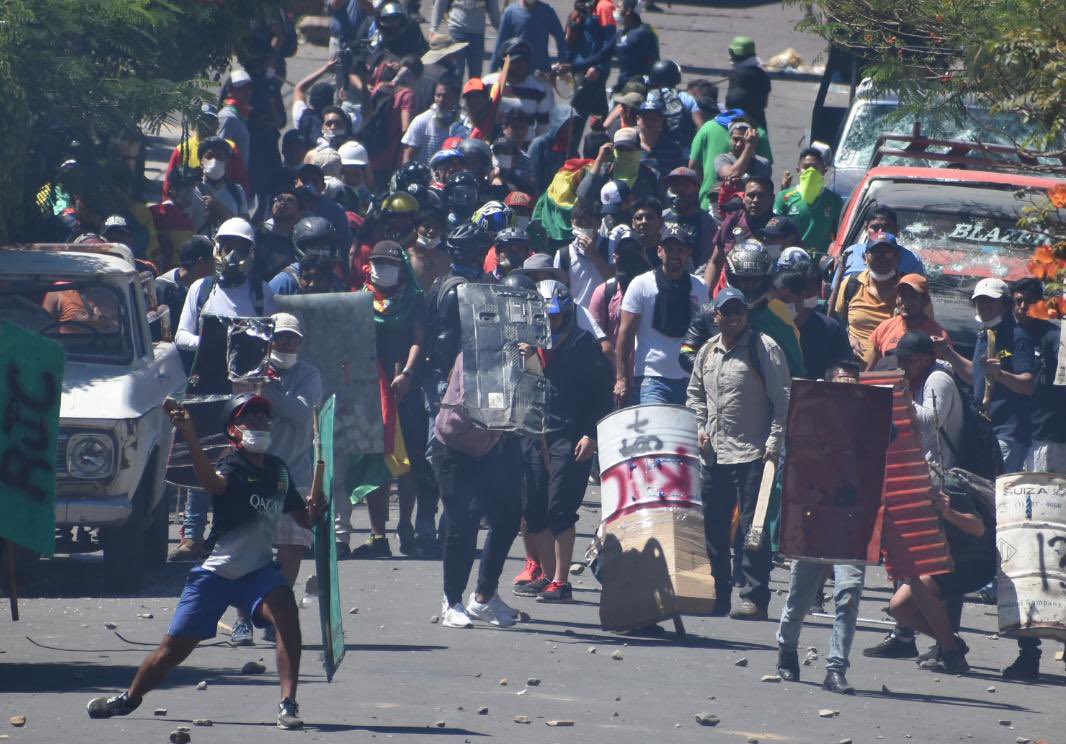 Opinion_Bolivia's tweet photo. El historico Pueblito de #Cochabamba se ha convertido en campo de batalla. Hay  varios vehículos destruidos, heridos y otra moto quemada. Los enfrentamientos en la zona de la Muyurina continúan.
📸 Dico Solís. https://t.co/VFga3Wc0AC