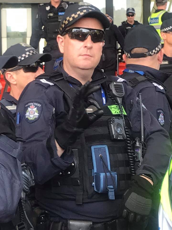 redblacknotes's tweet image. Victoria Police officer at the IMARC blockade flashing white nationalist hand signal at protestors.

In case you had any doubt which side @VictoriaPolice
 are on. #BlockadeIMARC #SpringSt #fcknzs #antifa